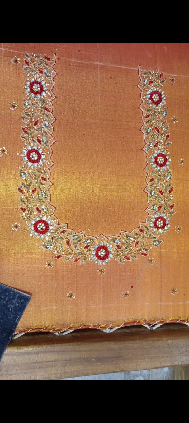 Orange gradient saree with ornate red floral zari embroidery border