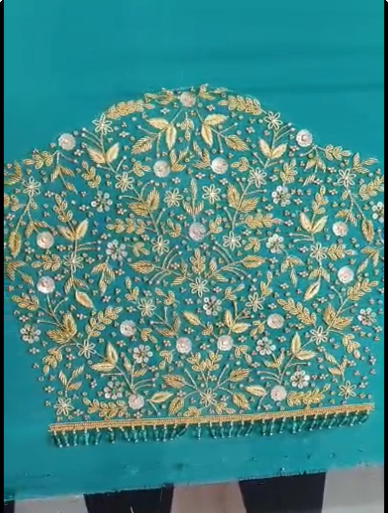 Turquoise bridal blouse with dense gold zari and floral maggam work