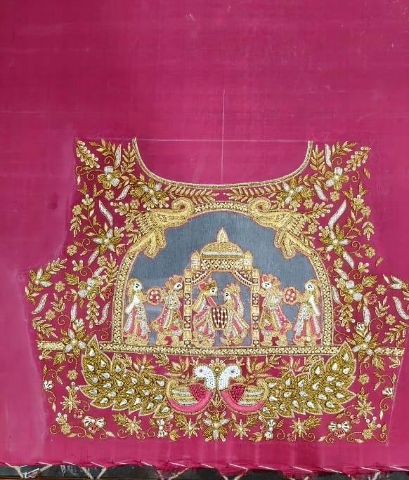 Maroon bridal blouse with gold zari embroidery and temple motif