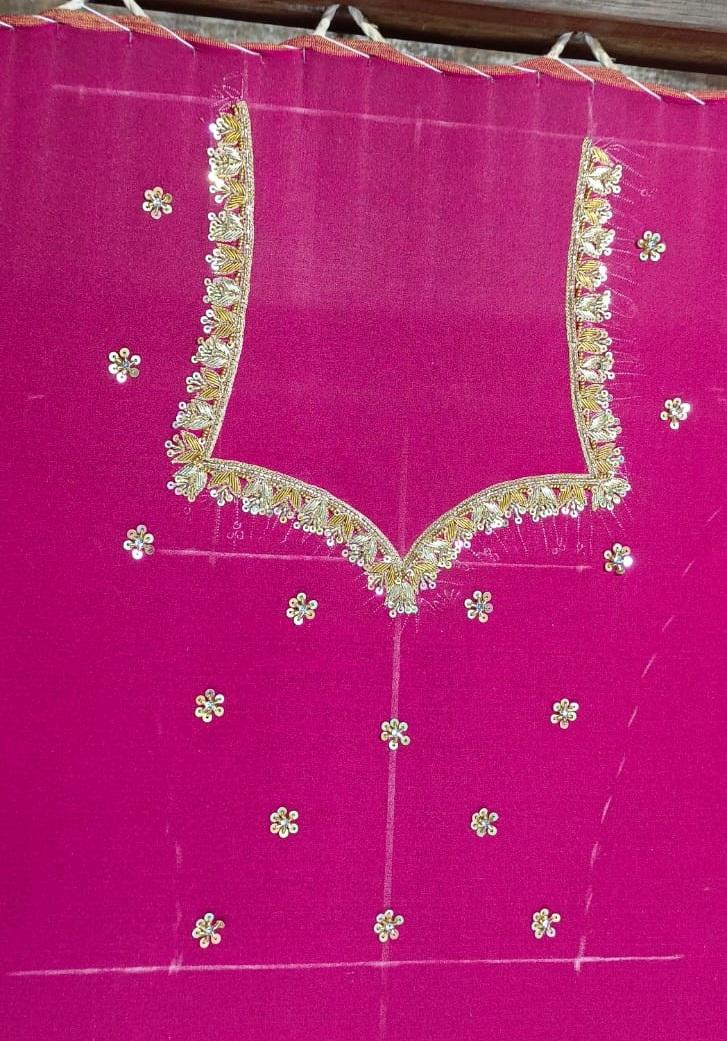 Bright pink blouse with gold zari border and floral embroidery