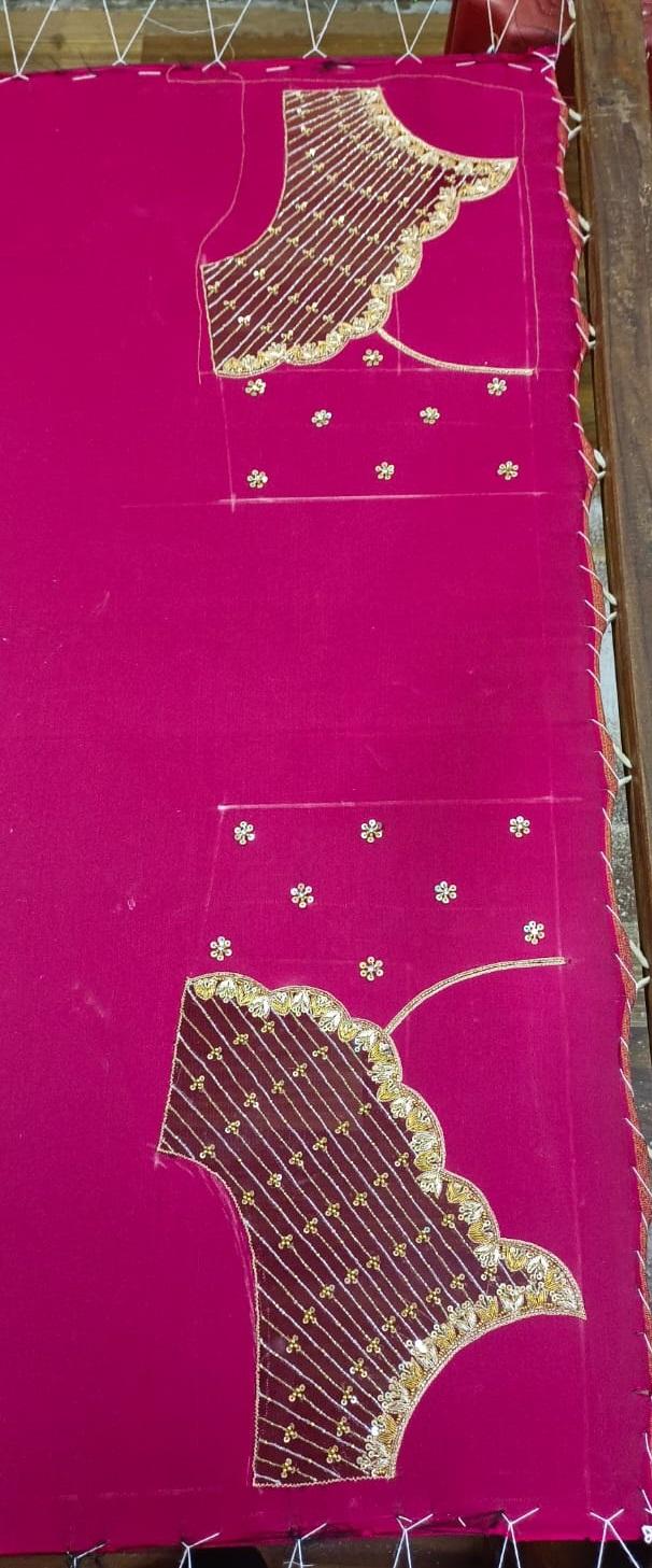 Bright pink saree with ornate gold zari embroidered pallu and scattered embellishments