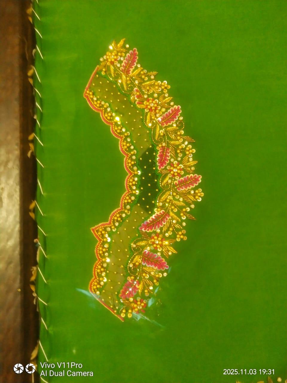 Green saree with ornate gold and pink zari floral border embroidery