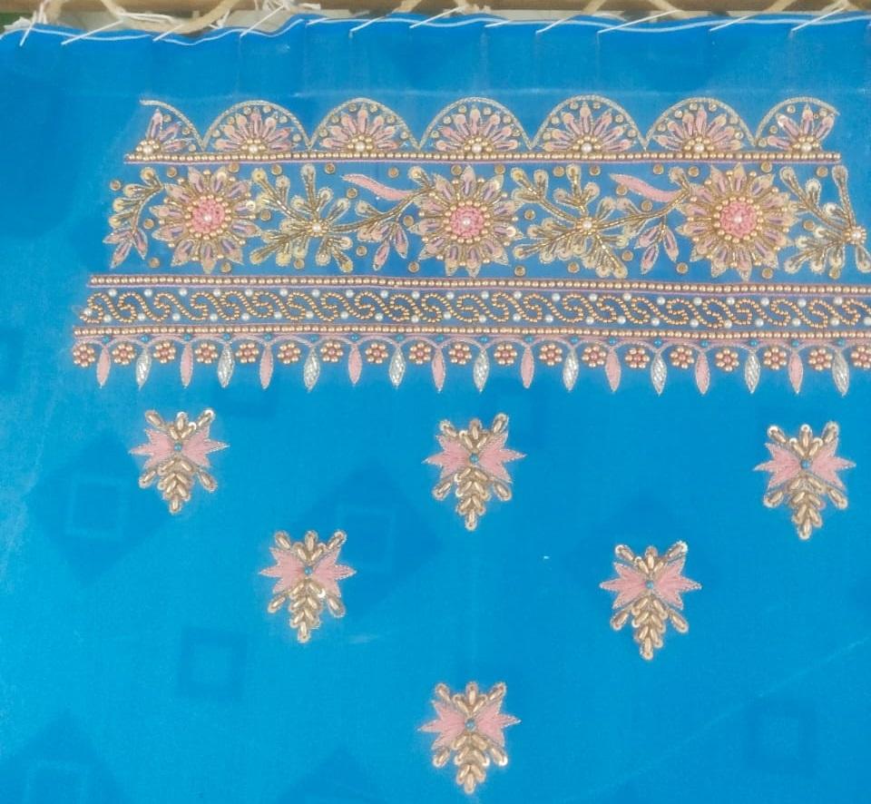 Blue saree with gold zari embroidery and pink floral motifs