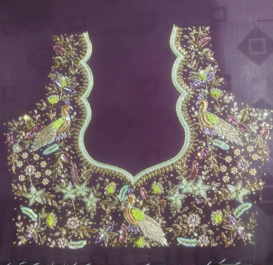 Maroon bridal blouse with intricate golden zari and maggam work embroidery