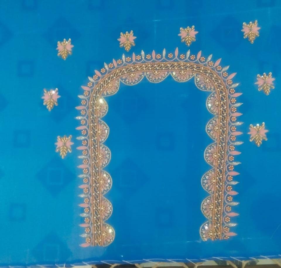 Blue saree with ornate gold zari border and floral embellishments