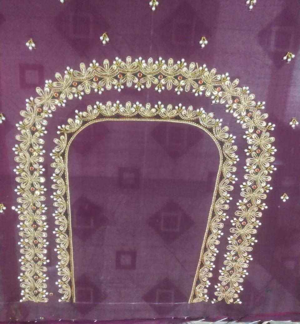 Purple bridal blouse with ornate gold zari floral embroidery and embellishments