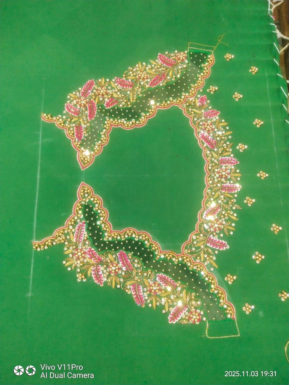Green saree with elaborate gold zari and pink floral maggam work border