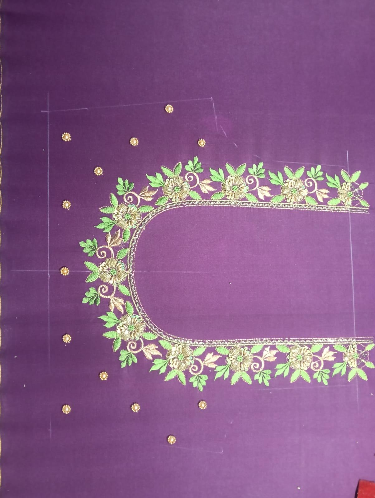 Purple saree with green and gold floral embroidery border design