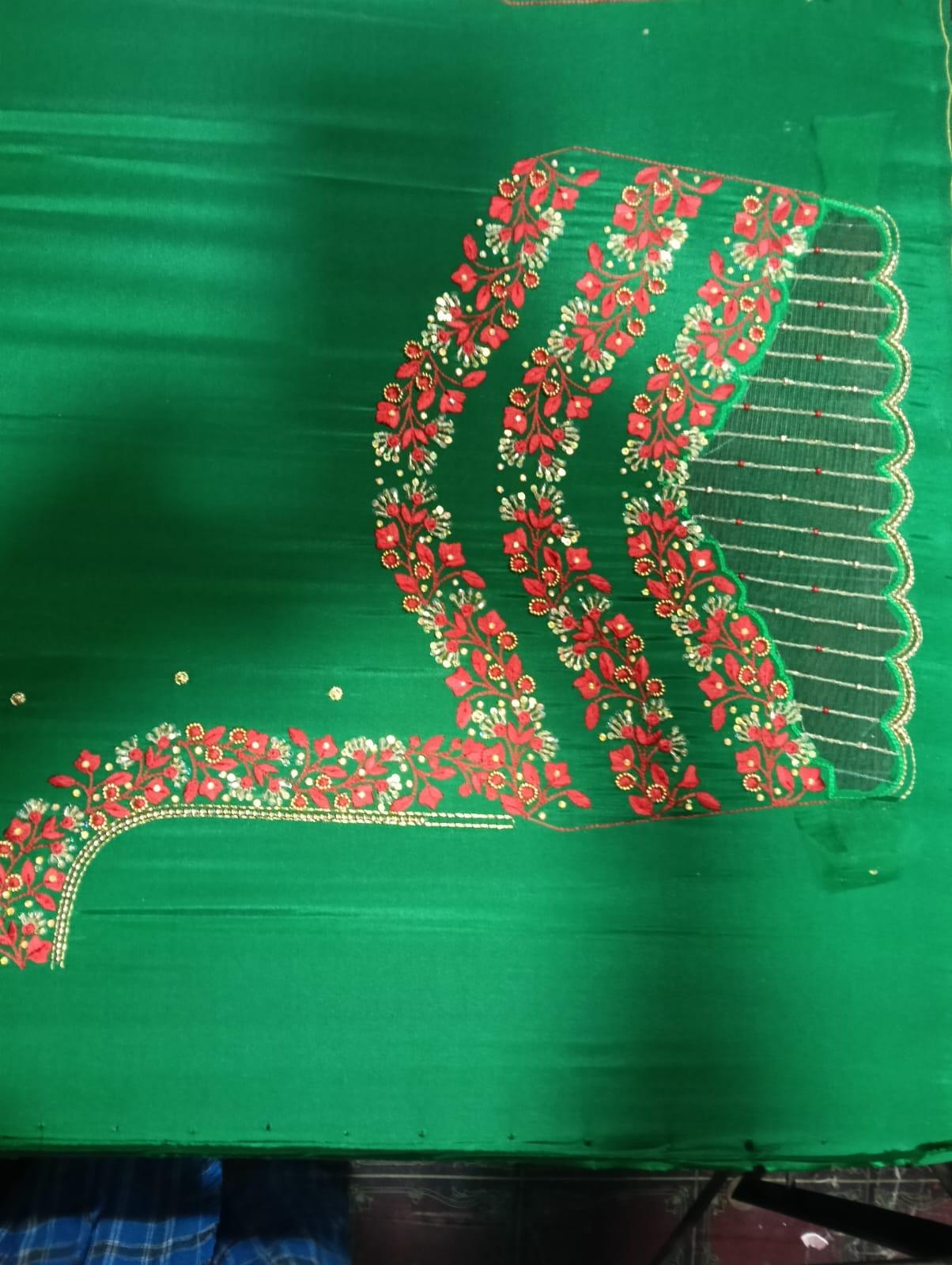 Green blouse with red floral maggam work and scalloped edges
