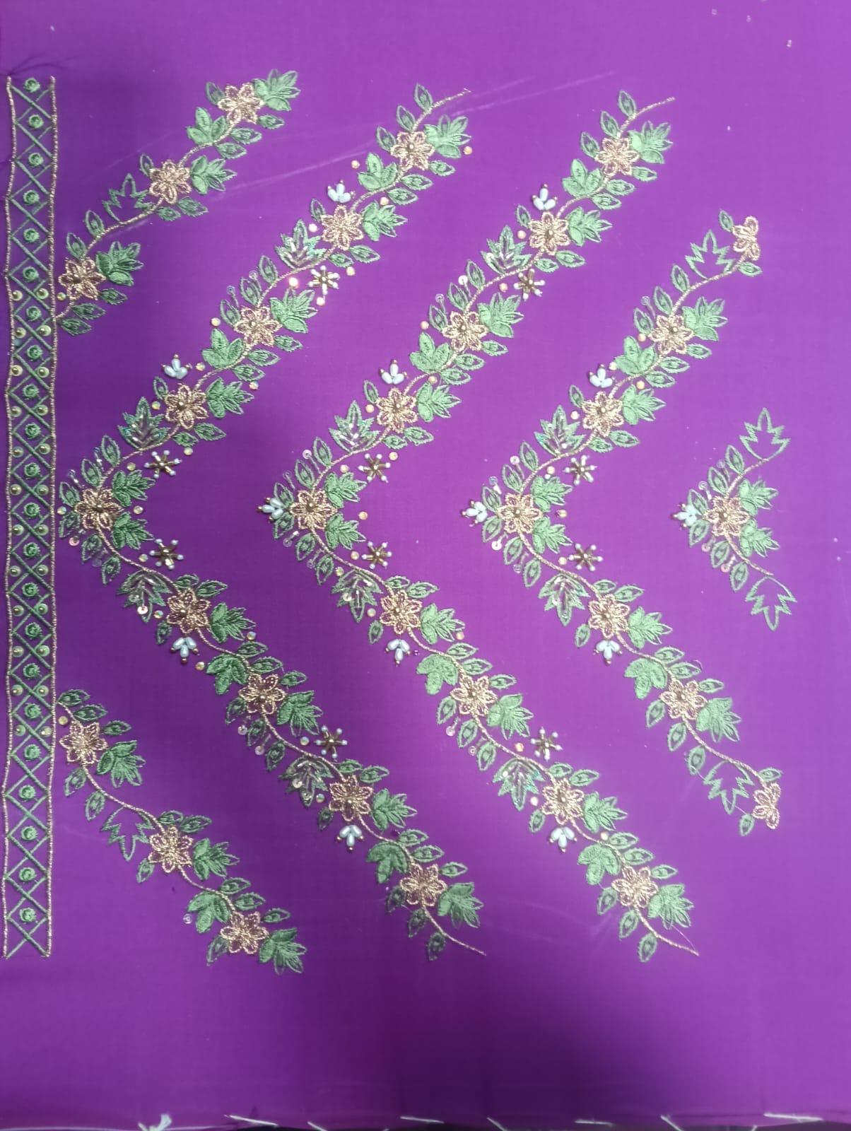 Purple silk saree with gold zari floral embroidery and green leaf details