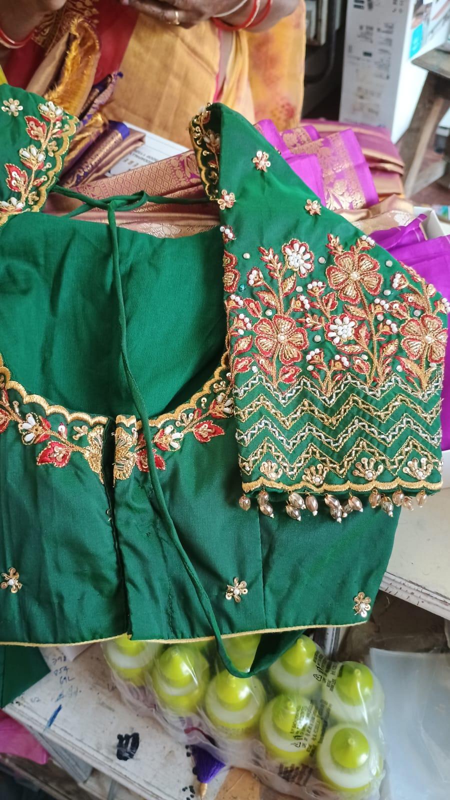 Green maggam work blouse with floral embroidery and gold detailing