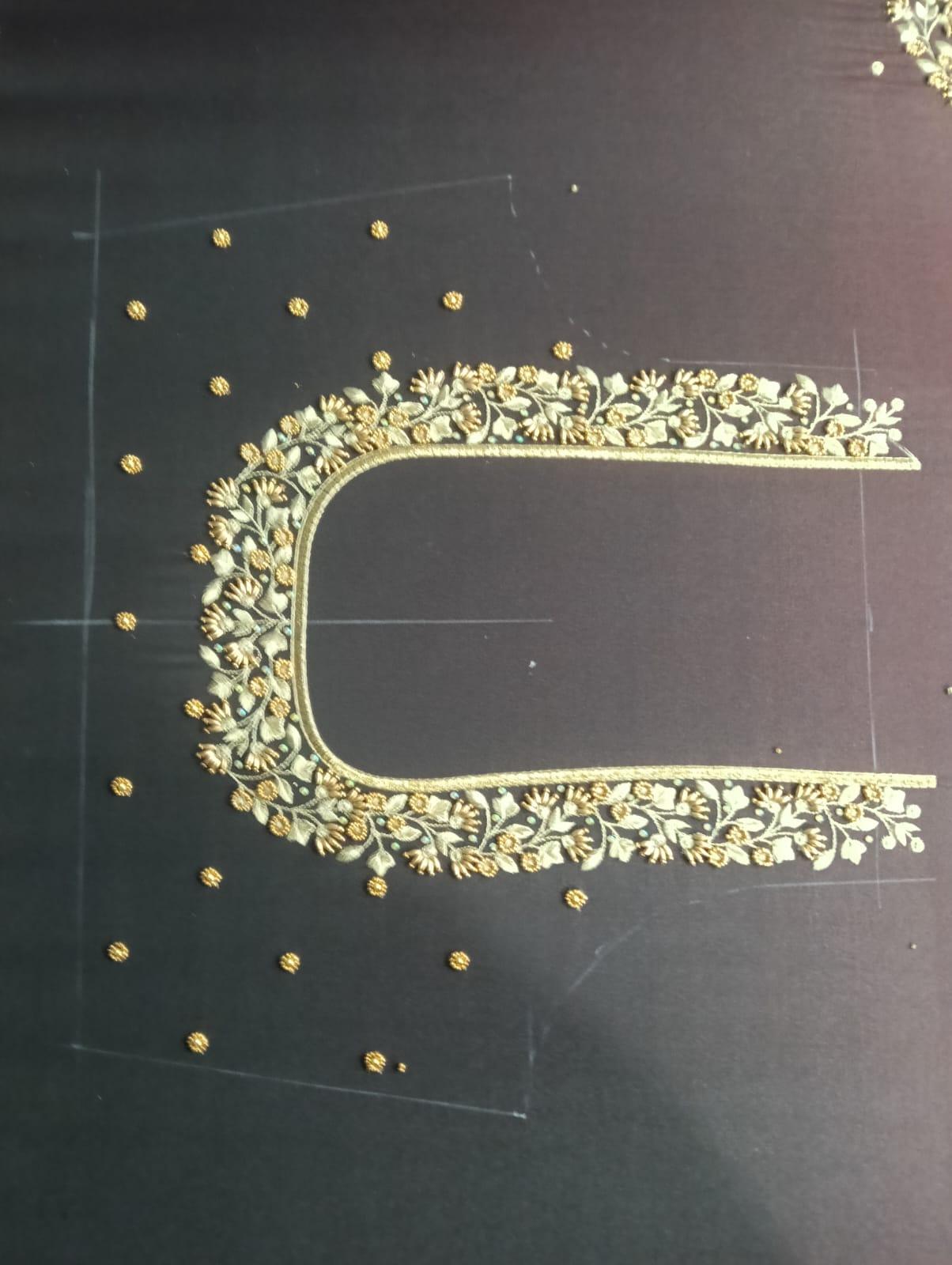 Black blouse with ornate gold zari embroidery and studded details