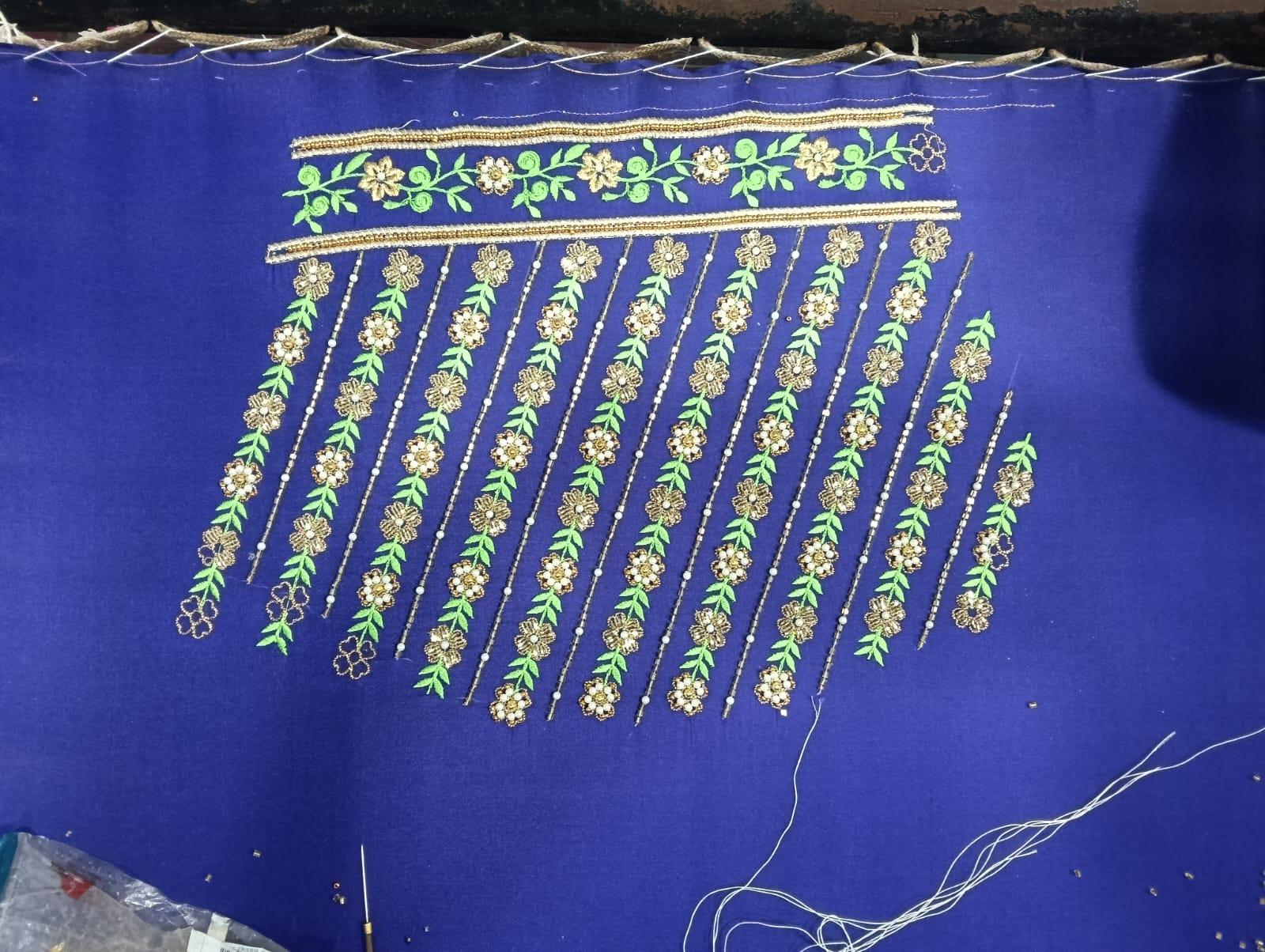 Royal blue saree with gold zari floral hanging work design