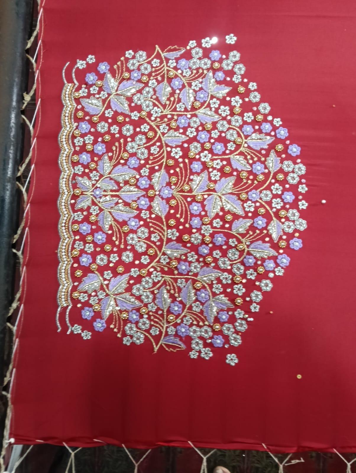 Red saree with intricate zari floral and leaf embroidery design