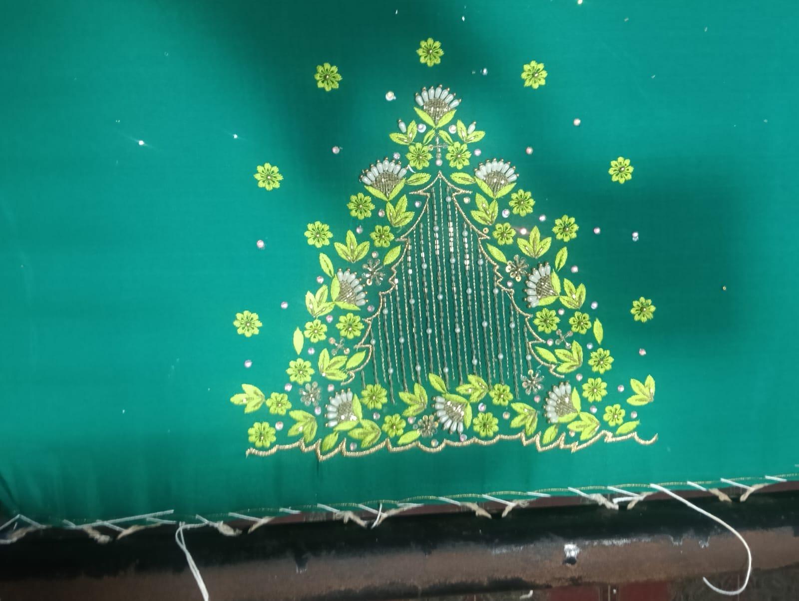 Green saree with yellow floral embroidery and decorative maggam work