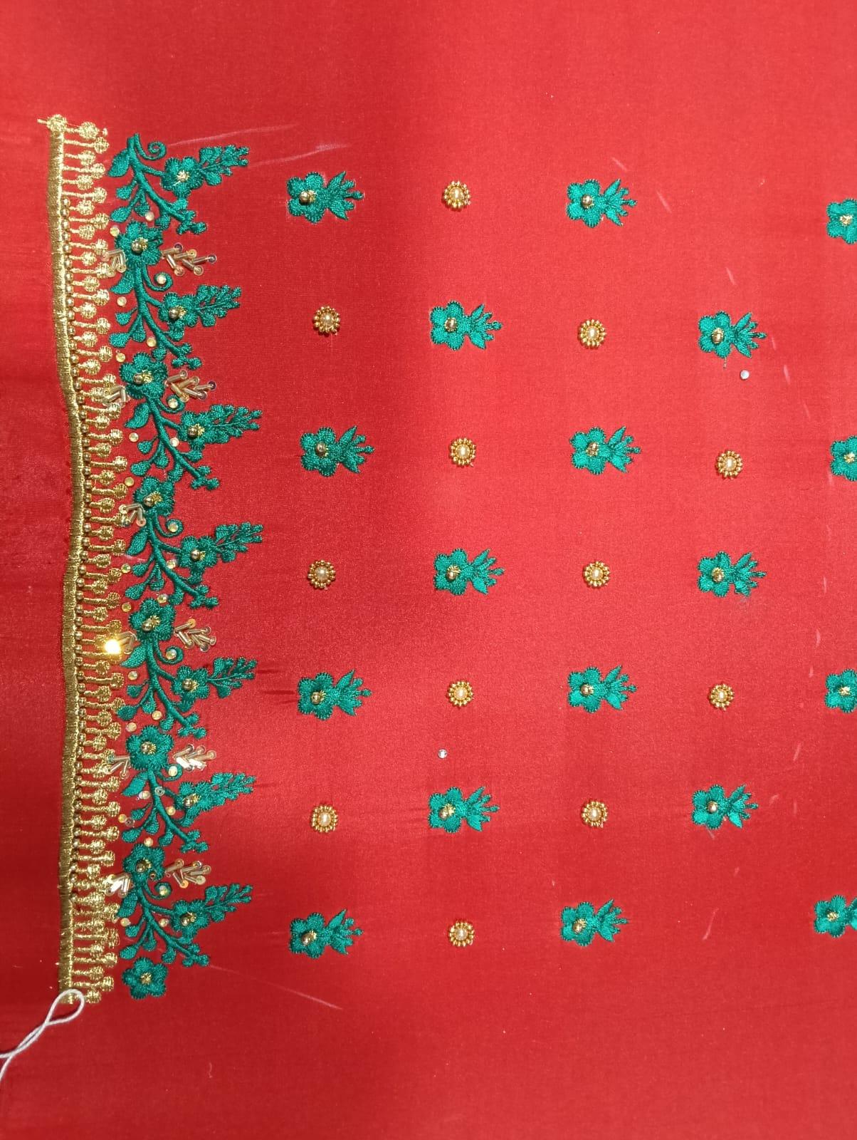 Red saree with turquoise floral embroidery and gold zari border