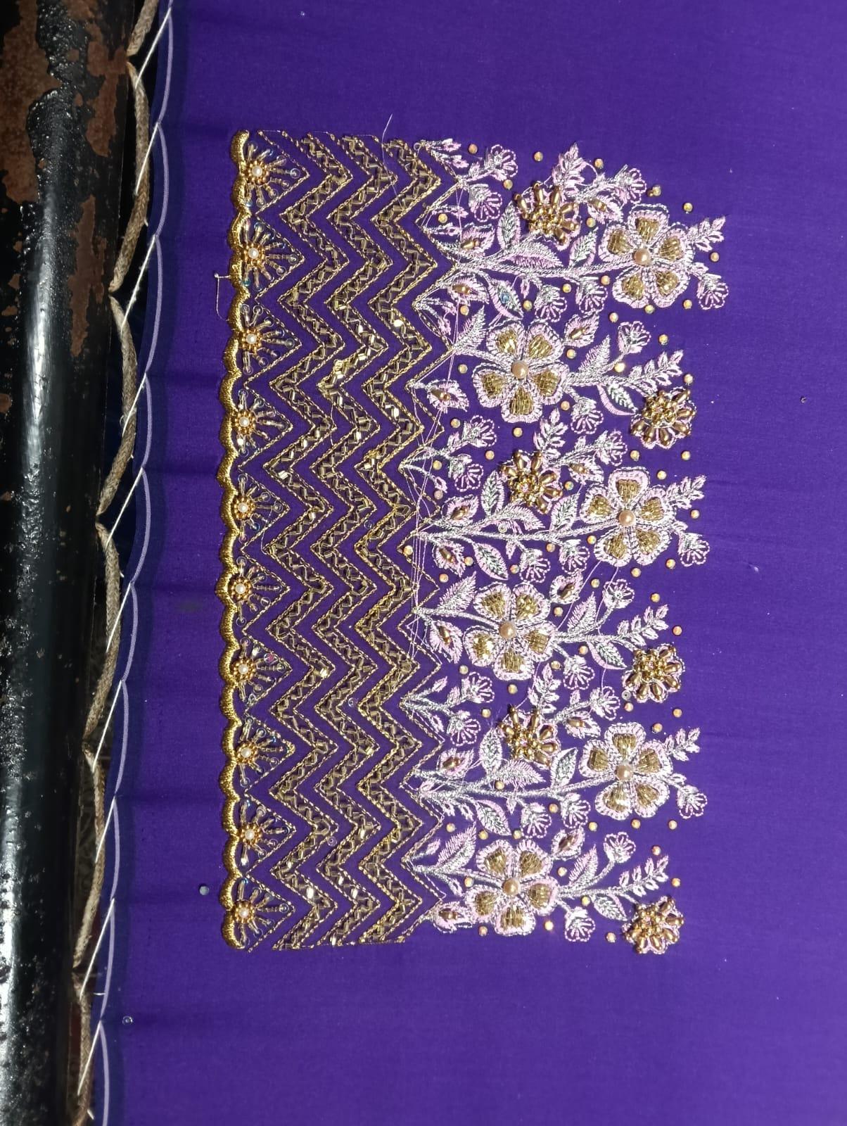 Purple fabric with gold and silver floral embroidered border design