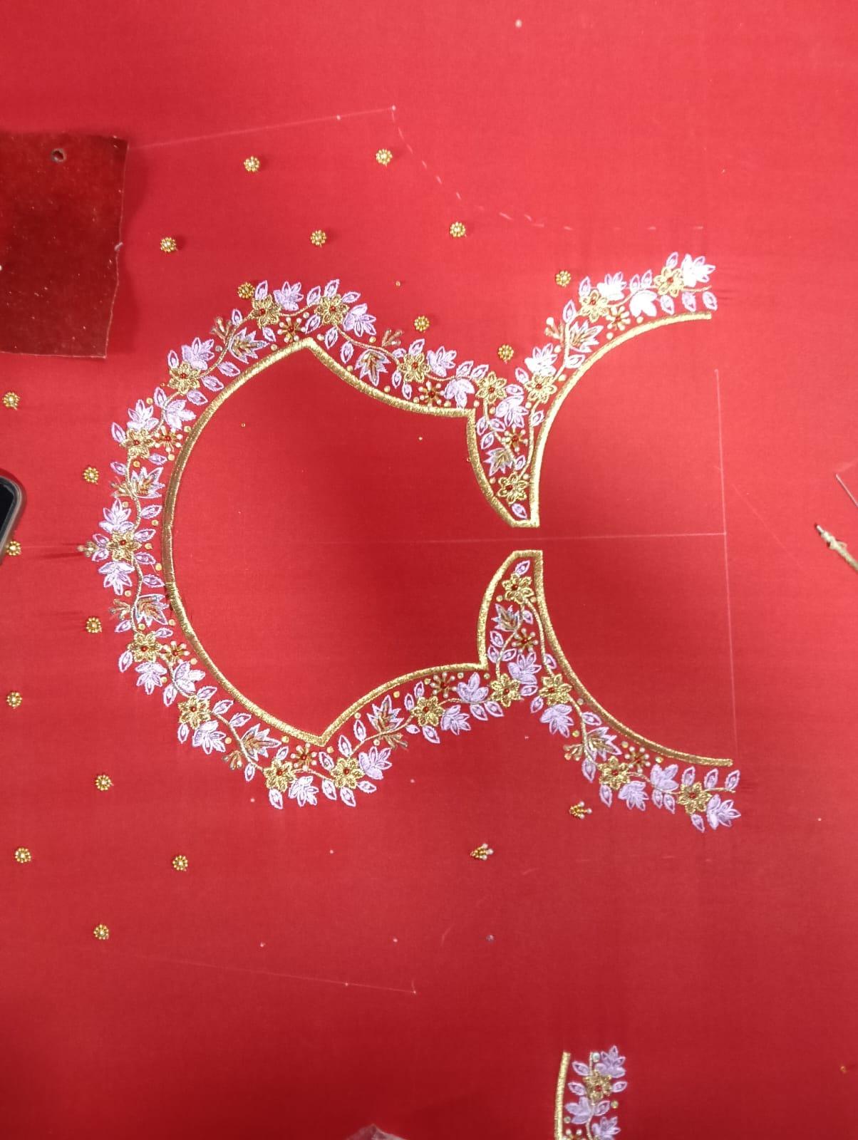 Red saree with gold zari and pink floral embroidery border