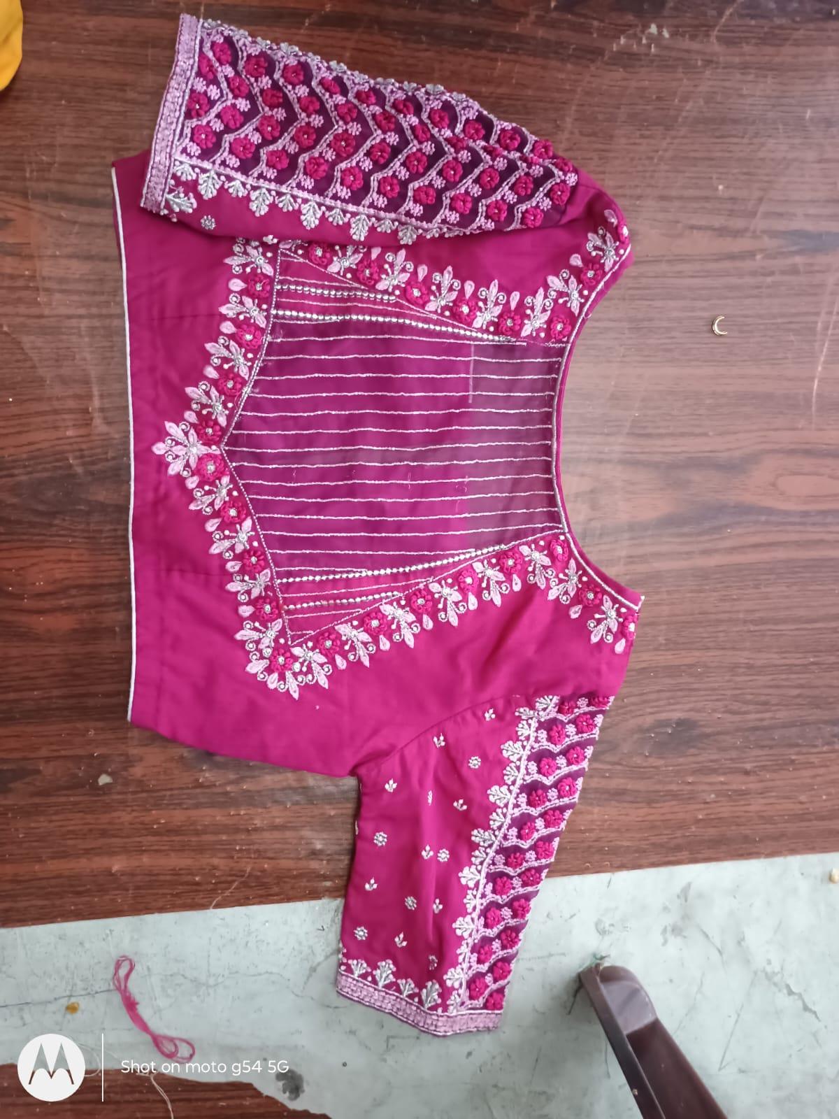 Magenta blouse with intricate white zari and floral embroidery work