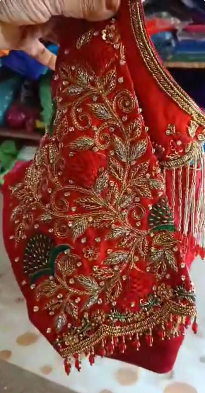 Red bridal blouse with gold zari embroidery and peacock motifs
