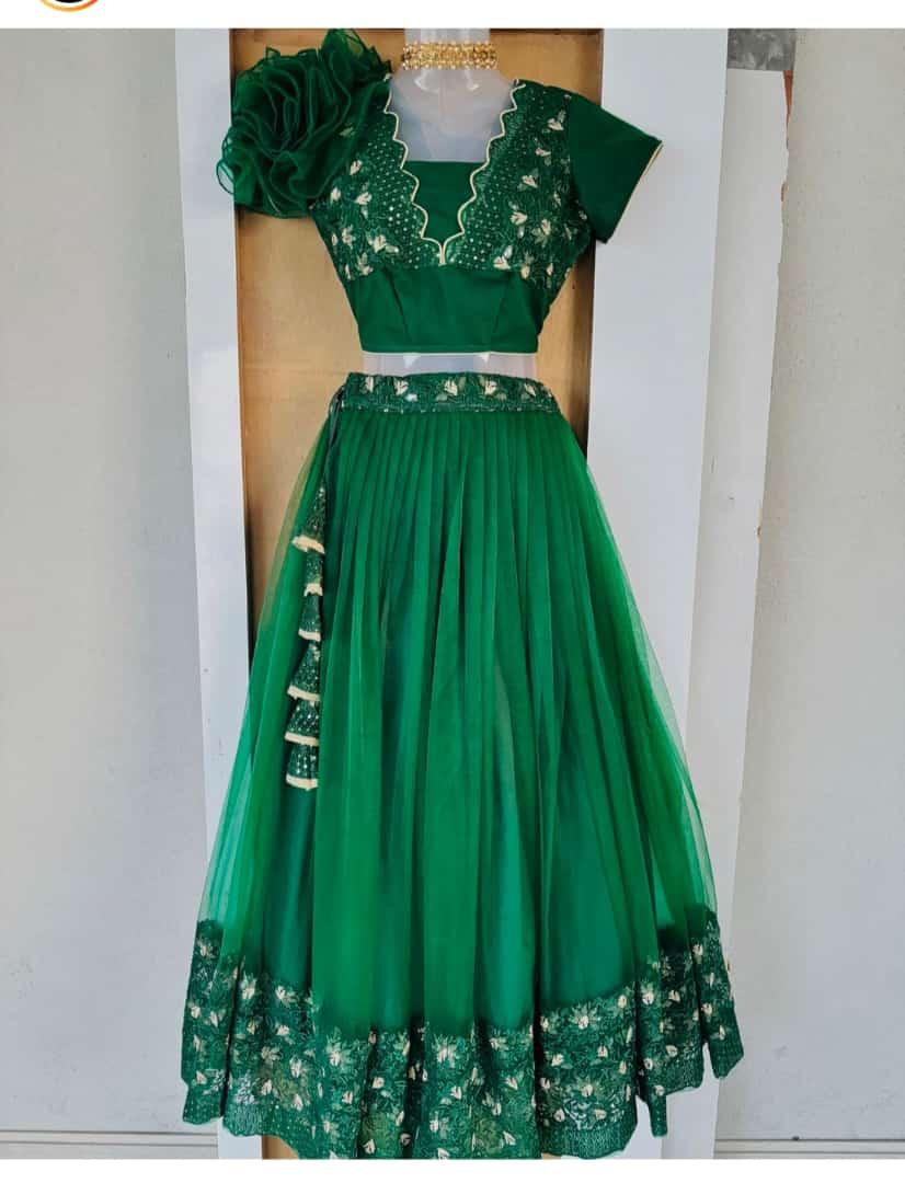 Green lehenga with embroidered blouse and pleated skirt