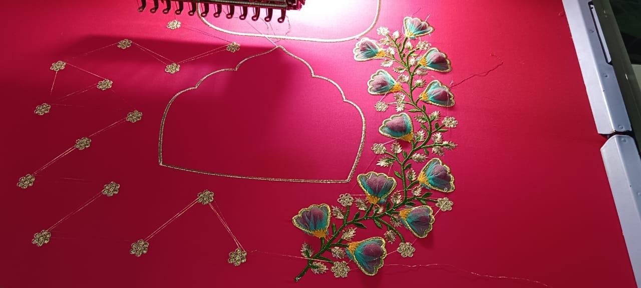 Pink bridal blouse with gold zari and colorful floral maggam embroidery