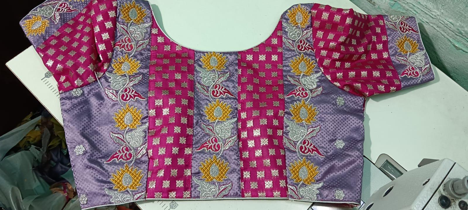 Purple maggam work blouse with gold sunflower motifs and zari stripes