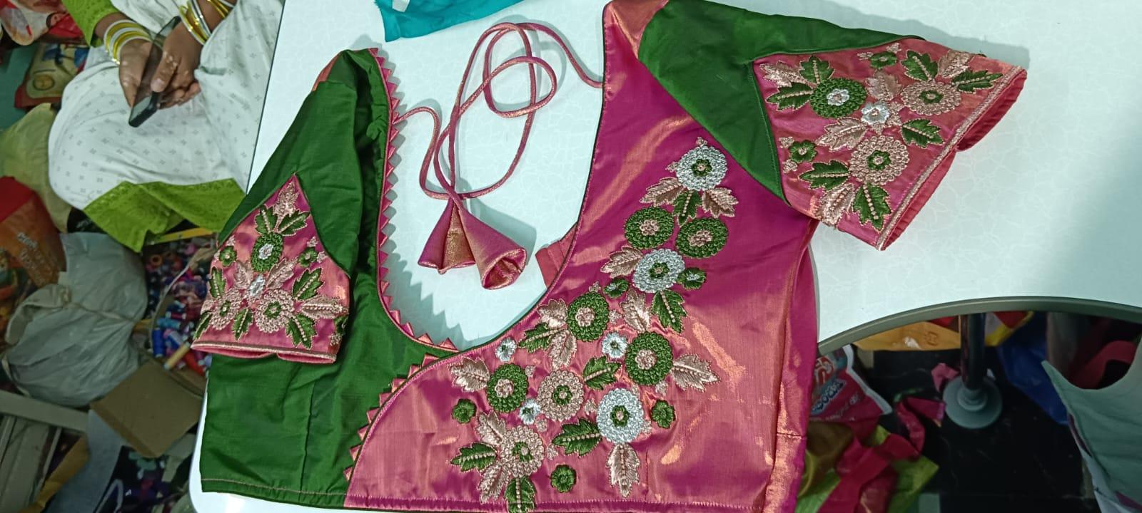 Pink-magenta blouse with green sleeves, ornate maggam work floral embroidery