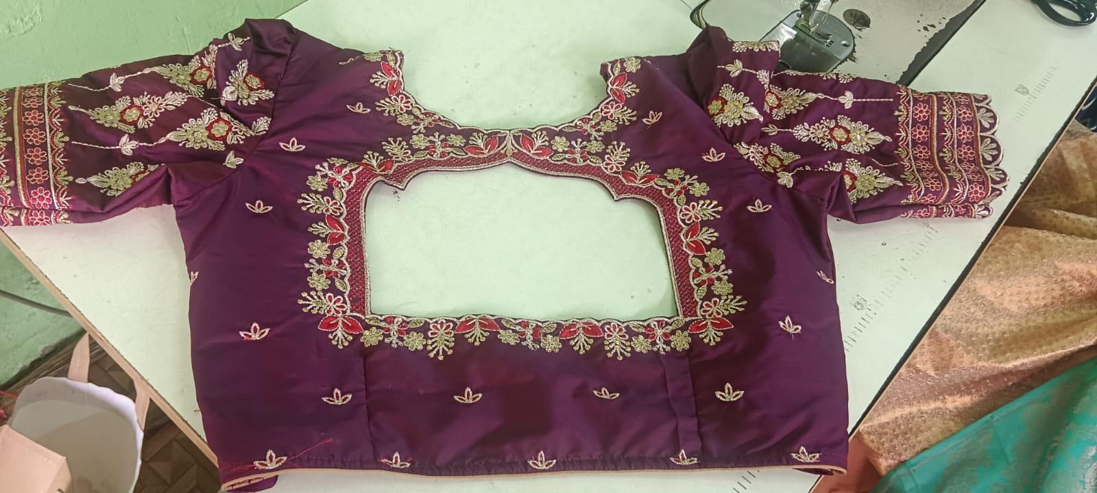 Maroon bridal blouse with gold zari and floral embroidery detailing