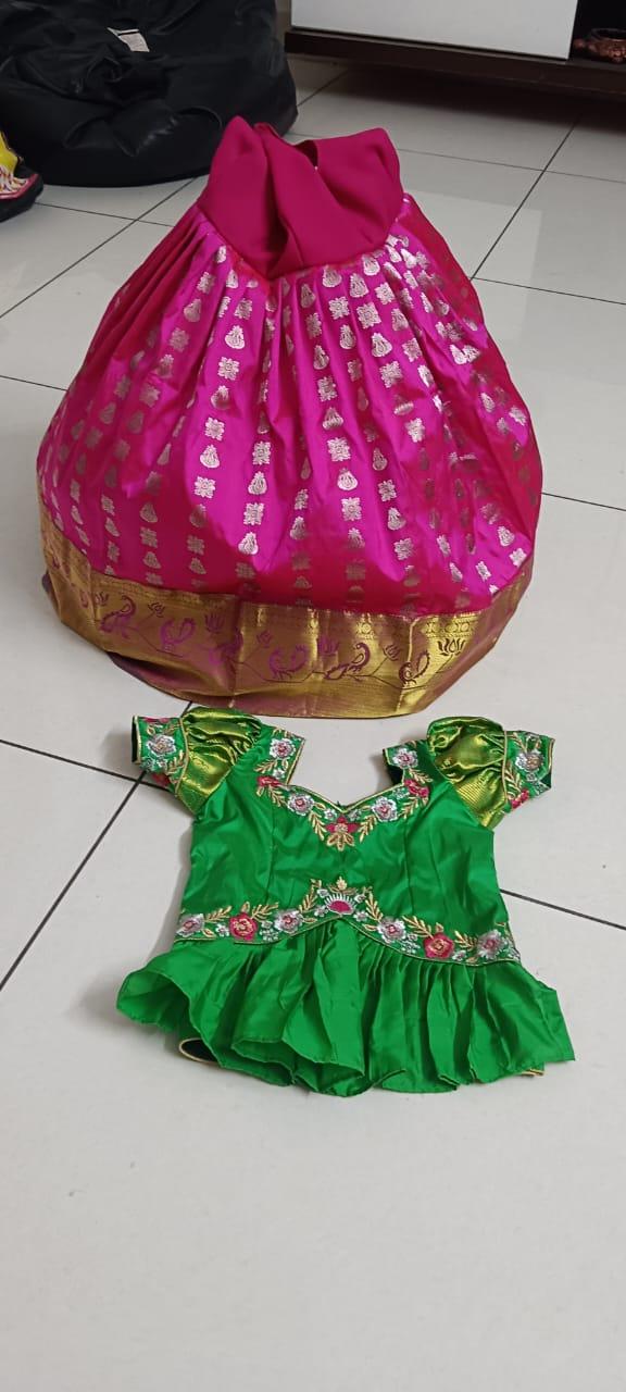 Magenta silk saree with gold zari border and matching green embroidered blouse