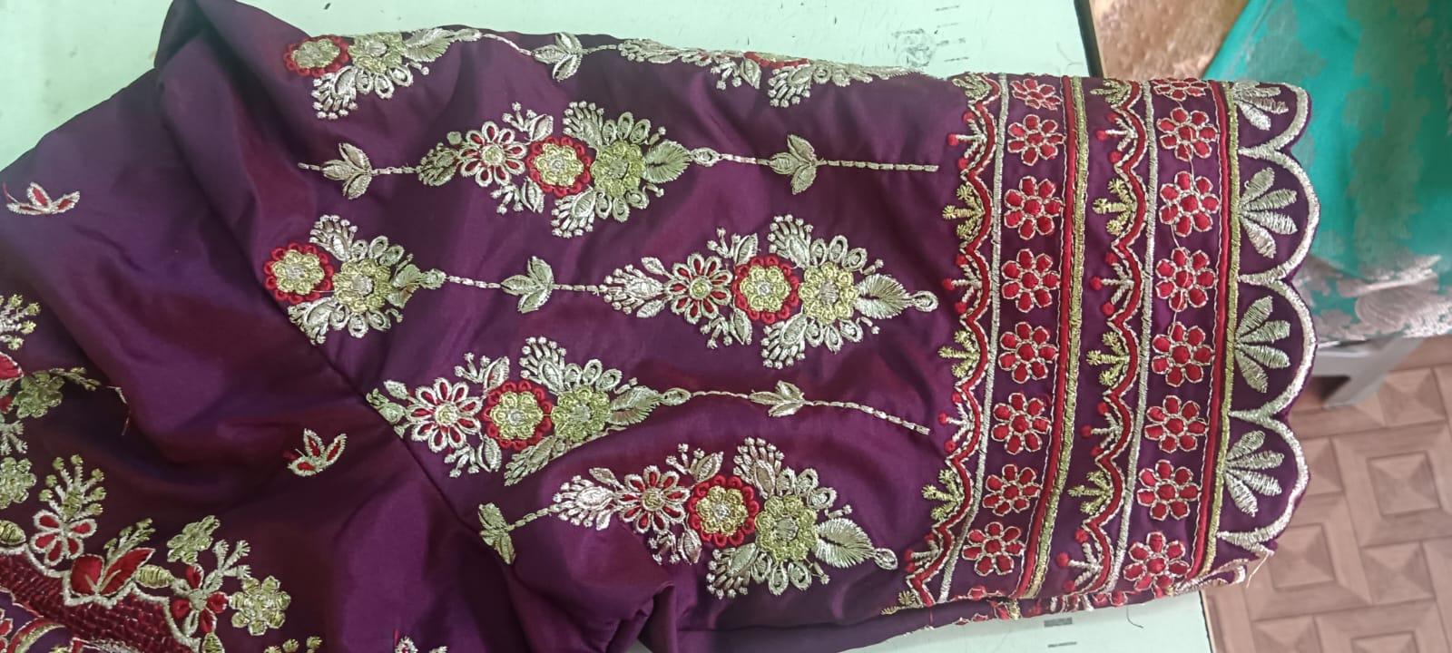 Purple saree with gold zari floral embroidery and red accents
