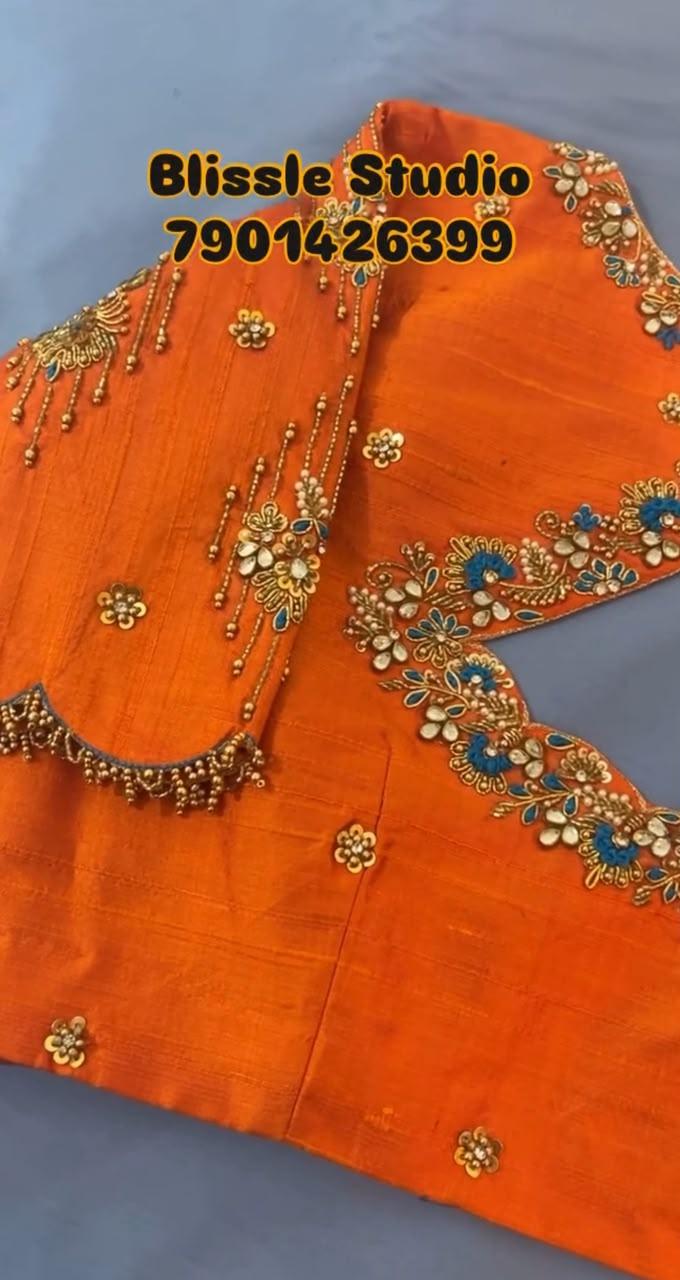 Bright orange bridal blouse with intricate gold and pearl maggam work