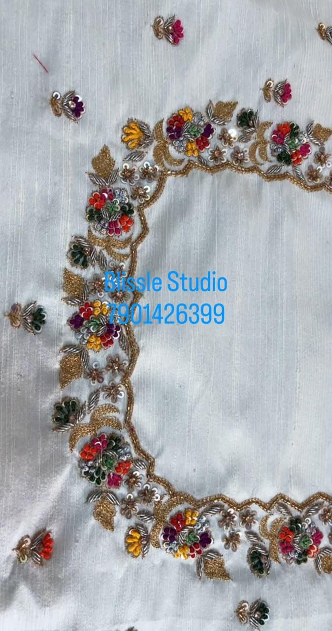 White fabric with ornate gold zari floral embroidery border trim