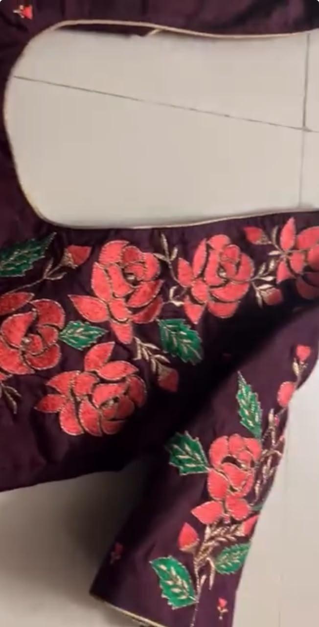 Dark purple saree with red floral embroidery and green leaf details