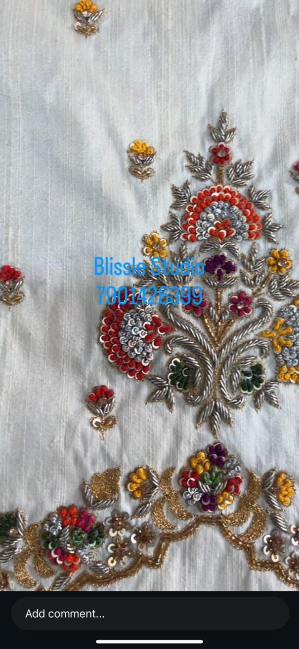 White fabric with intricate multicolor floral maggam work embroidery
