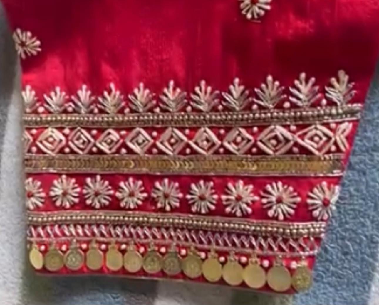 Red saree with gold zari embroidery and decorative borders
