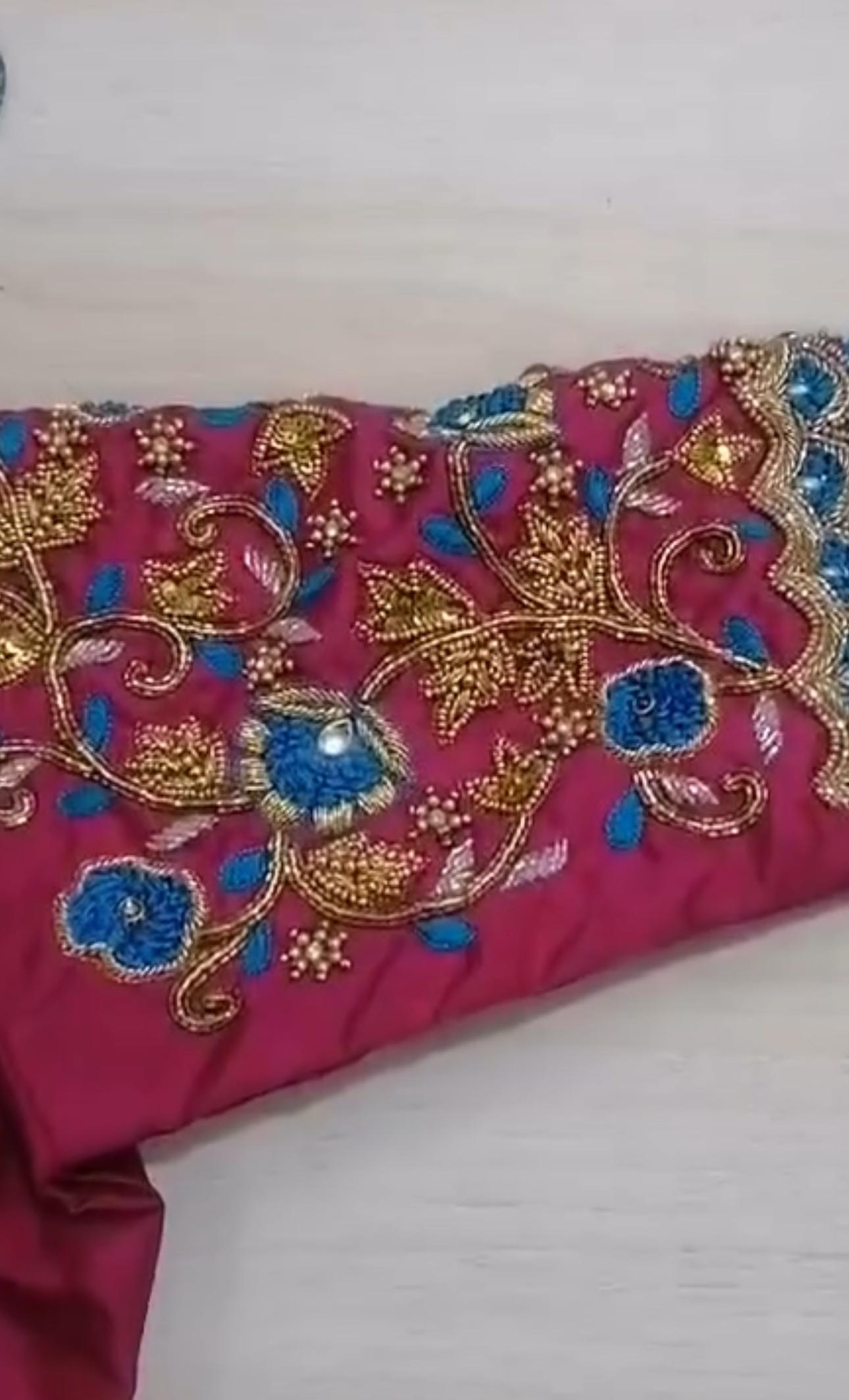 Maroon blouse with gold zari and blue floral maggam work embroidery