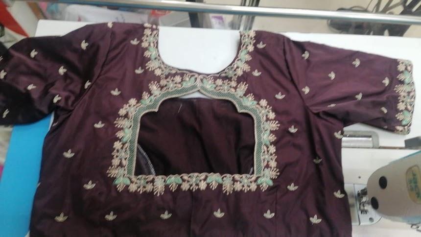 Maroon designer blouse with gold zari embroidery and intricate border work