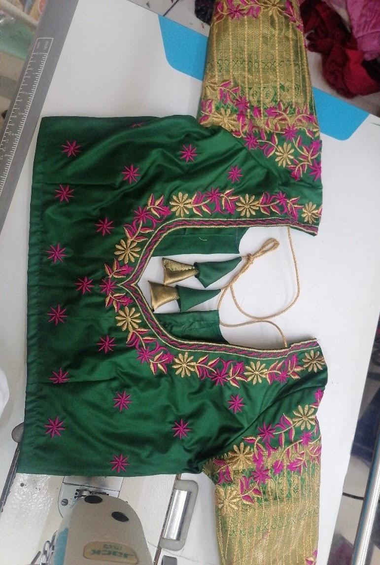 Green blouse with magenta and gold floral embroidery and decorative tassels