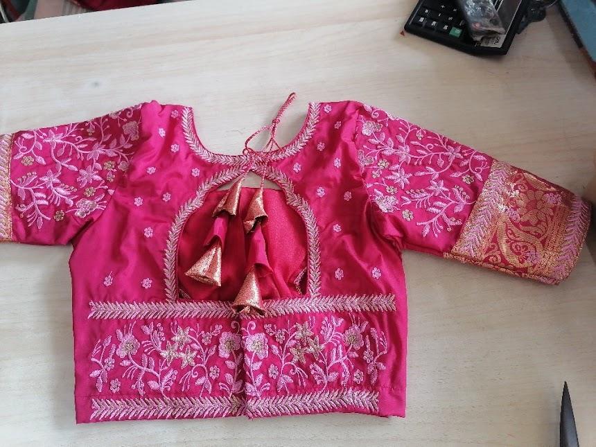 Magenta bridal blouse with gold zari embroidery and floral patterns