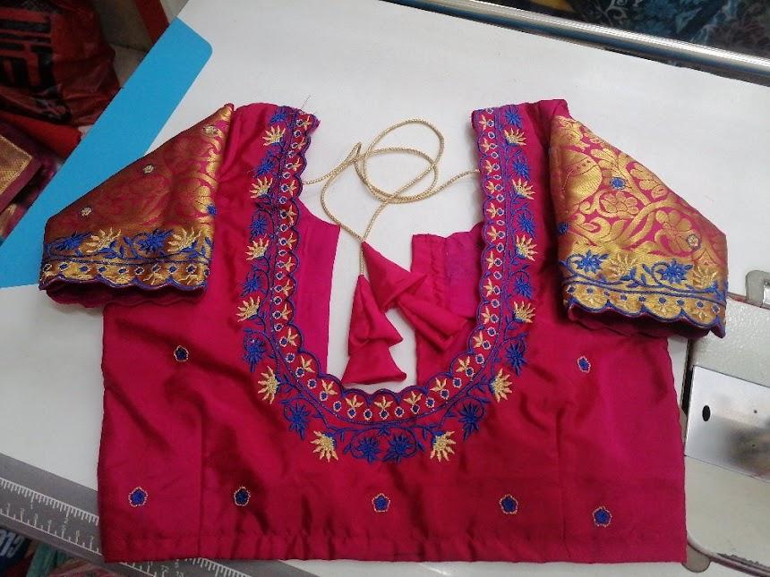 Red bridal blouse with gold and blue embroidered neckline and sleeves