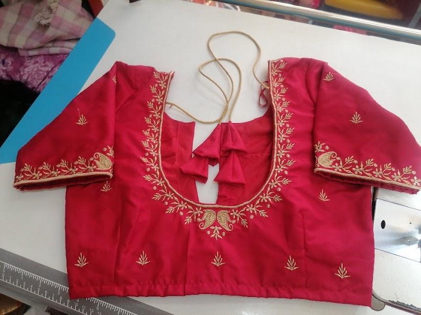Red bridal blouse with gold zari embroidery and floral motifs