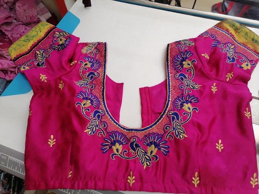 Magenta blouse with intricate maggam work embroidery and gold details