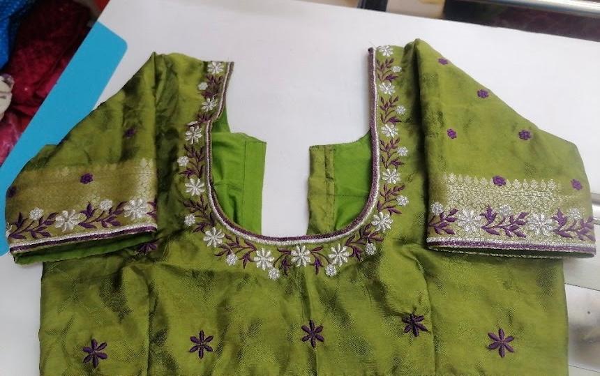 Green blouse with purple floral embroidery and golden zari border