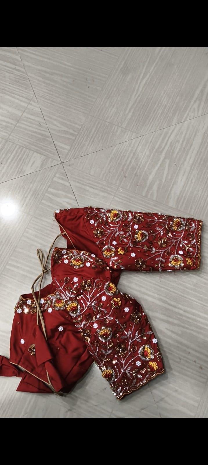 Red bridal blouse with floral embroidery and golden zari work
