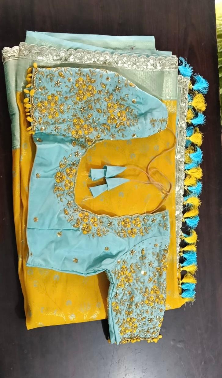 Yellow silk saree with light blue embroidered blouse and gold zari work