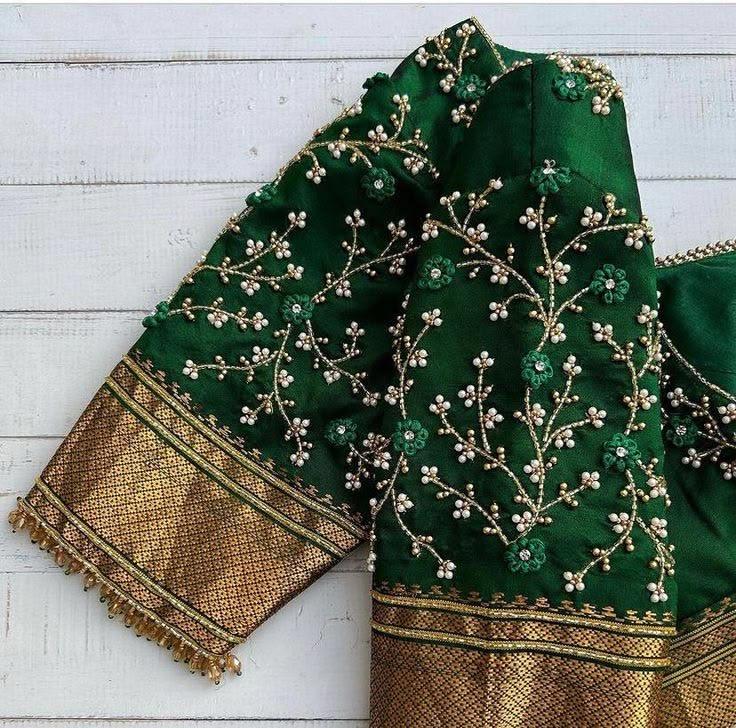 Green blouse with delicate floral embroidery and gold zari border