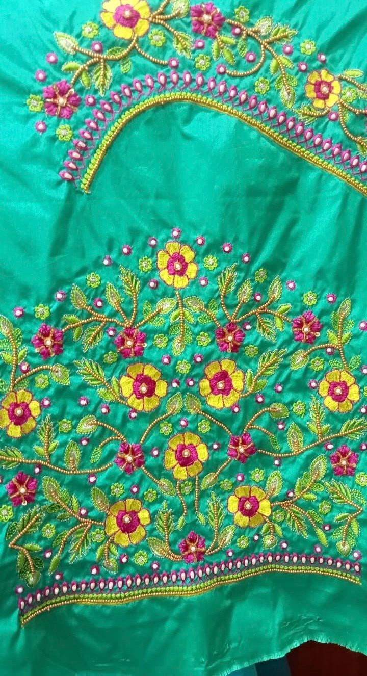 Turquoise saree with vibrant floral maggam work and beaded borders