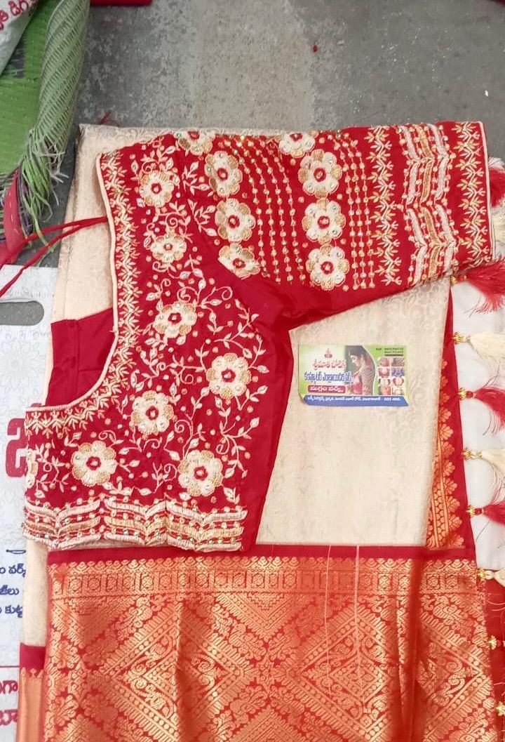 Red silk saree with cream floral zari embroidery and gold border
