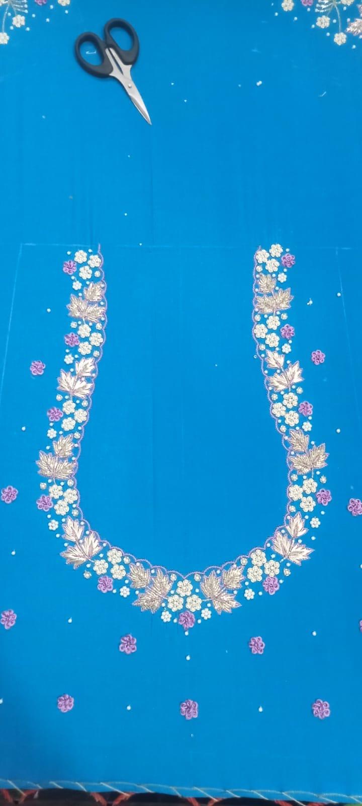 Blue neckline with gold floral embroidery and pink accents